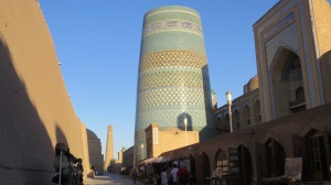 A street view in Khiva with the "unfinished" minaret in the foreground.